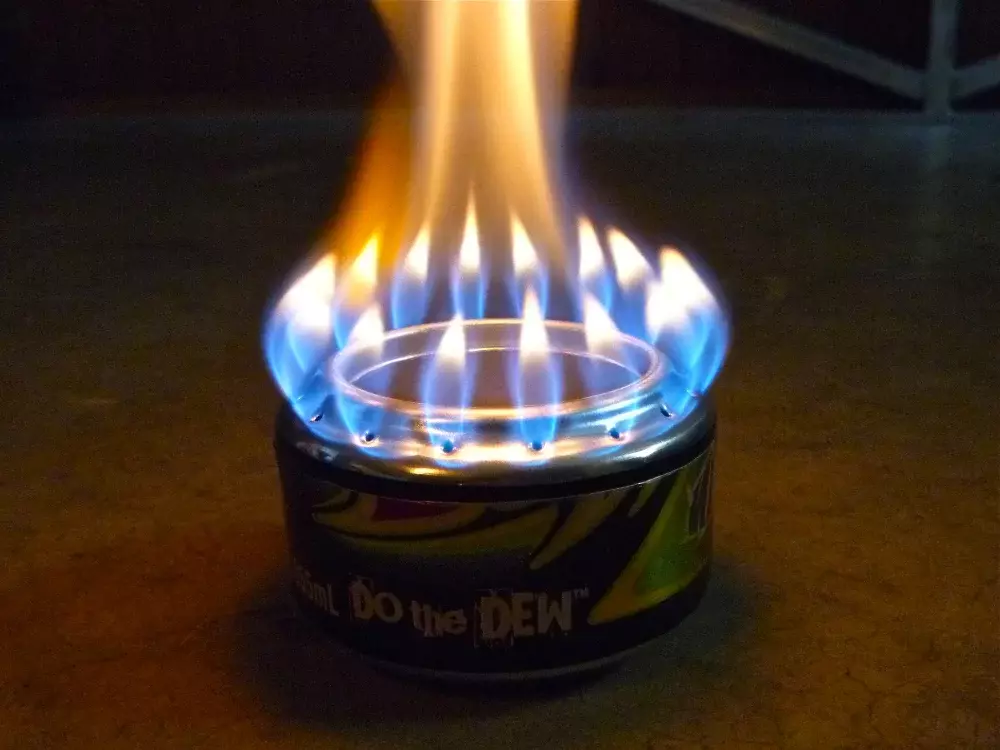 Picture of a lit alcohol stove made from a soda can